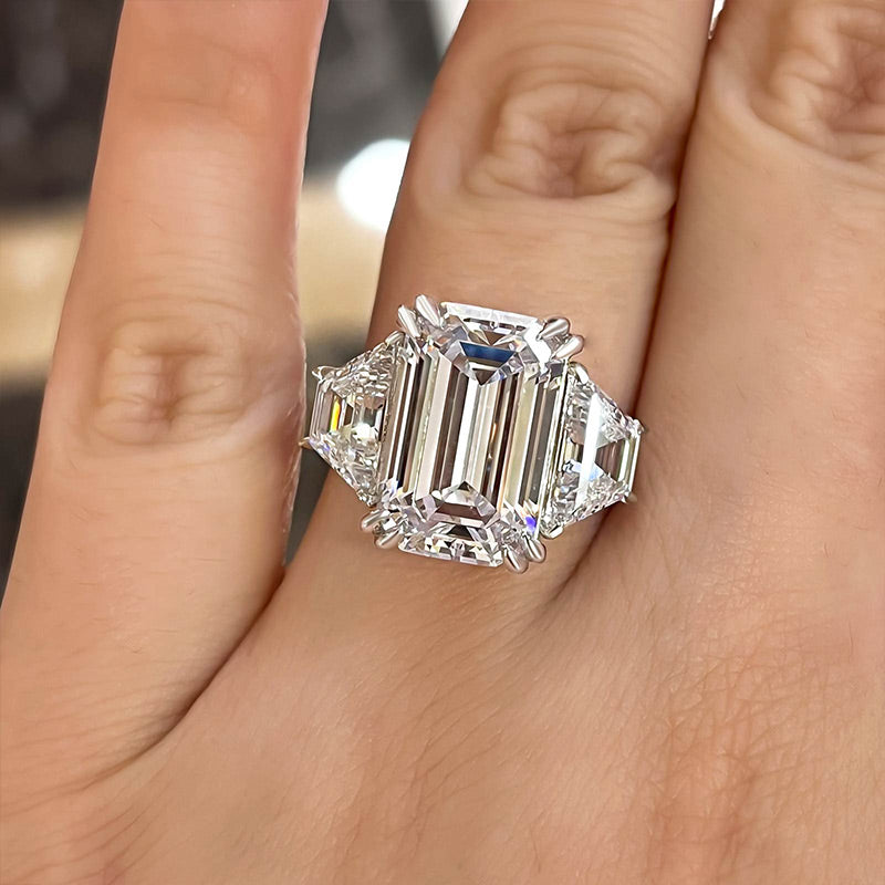 Luxurious Emerald Cut Three Stone Engagement Ring In Sterling Silver