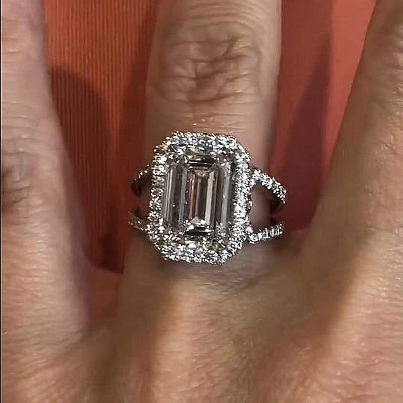 Noble Split Shank Halo Emerald Cut Engagement Ring In Sterling Silver