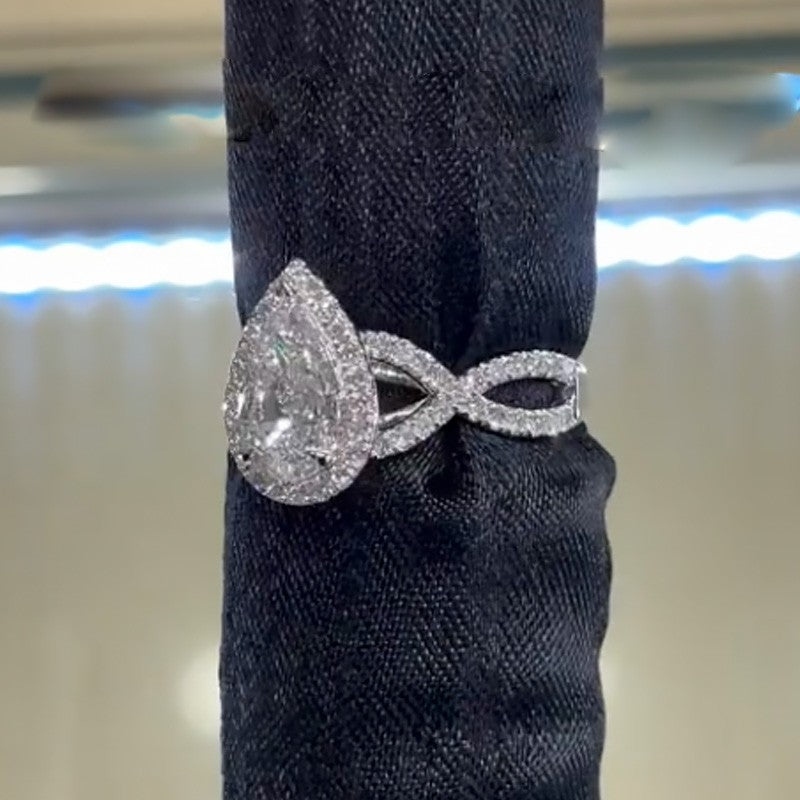 4.0Ct Halo Pear Cut Twist Travel Ring In Sterling Silver