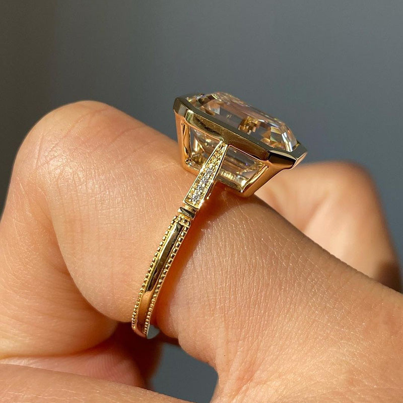 Luxurious Yellow Gold Emerald Cut Bezel Engagement Ring In Sterling Silver