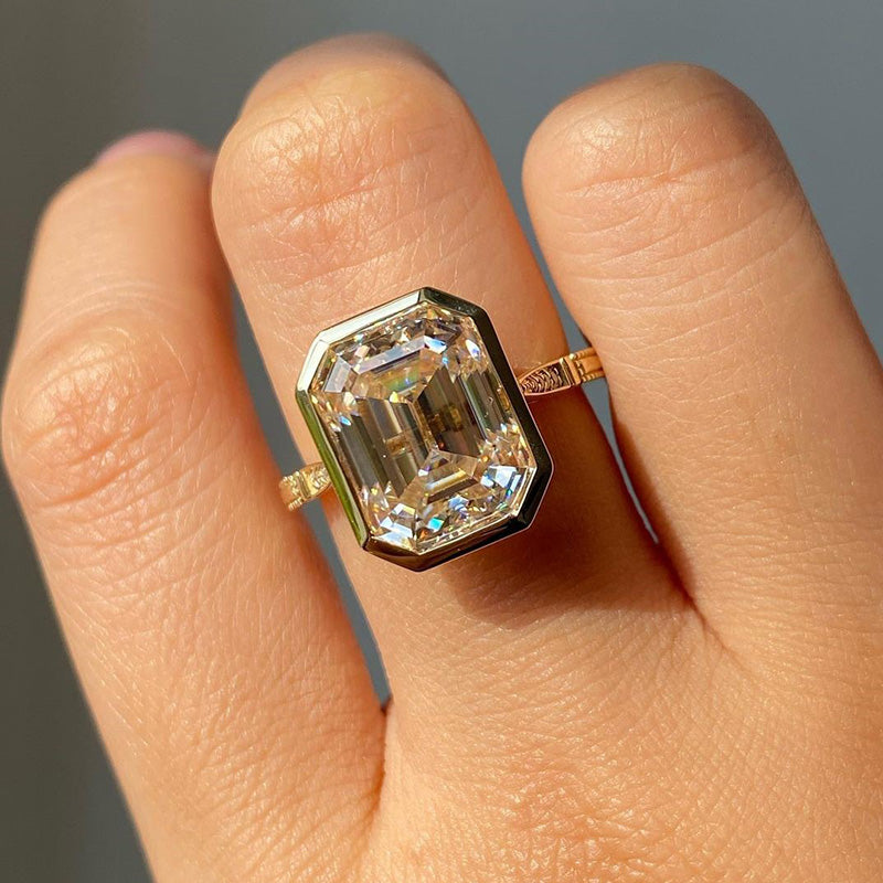 Luxurious Yellow Gold Emerald Cut Bezel Engagement Ring In Sterling Silver