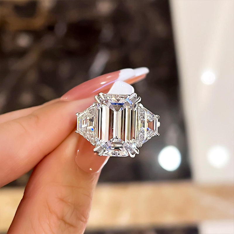 Luxurious Emerald Cut Three Stone Engagement Ring In Sterling Silver